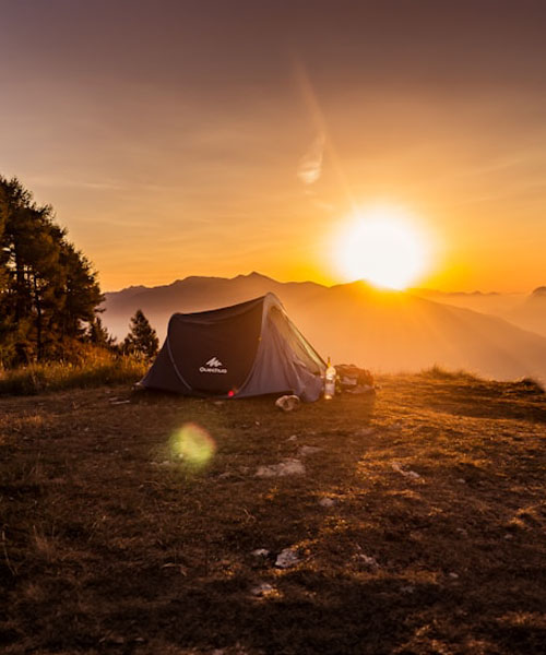 Tent on a mountain during sunset
