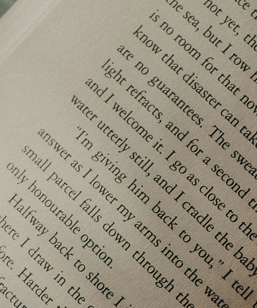 Person reading a book outdoors