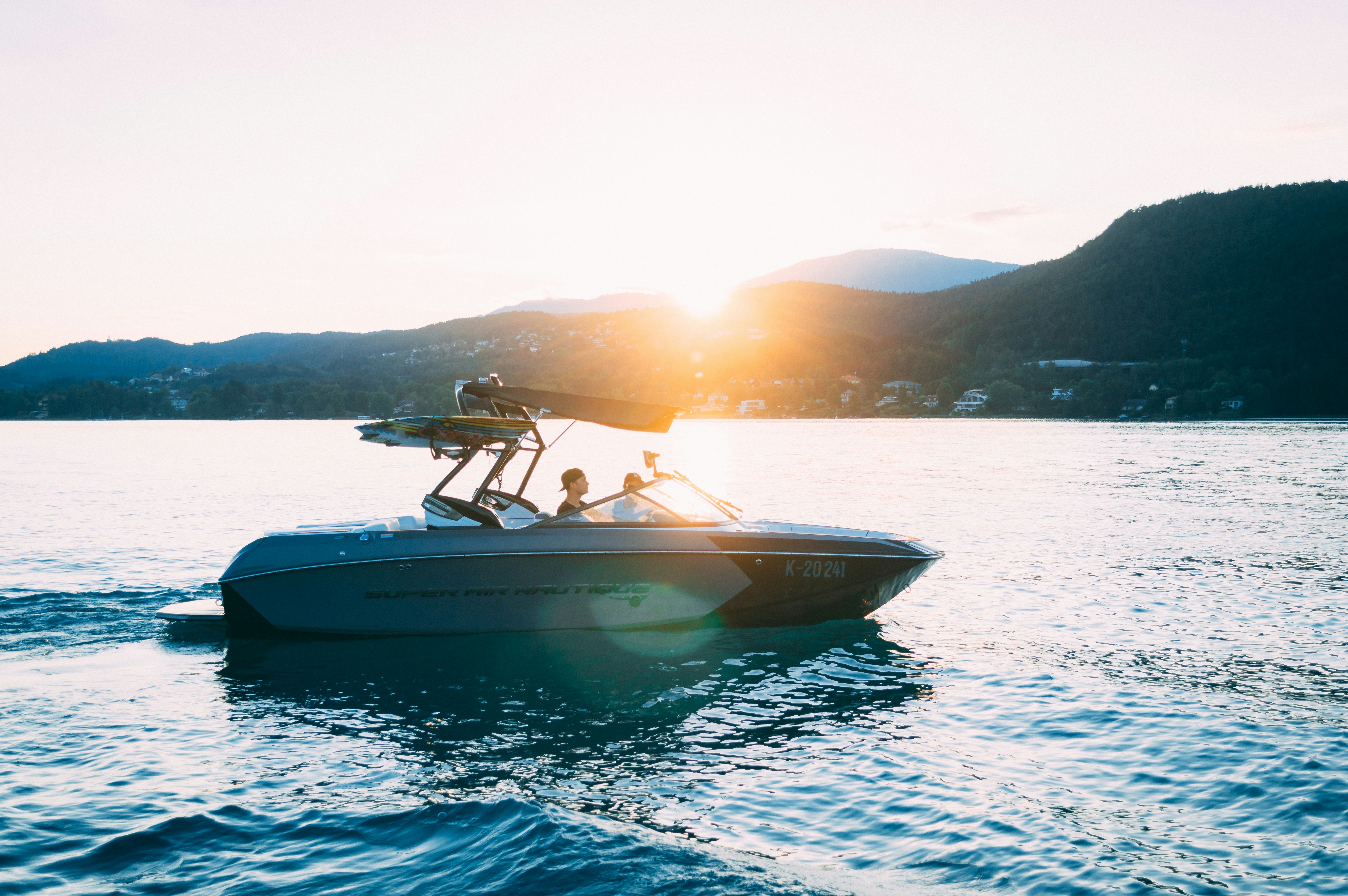 surf boat on lake golden hour