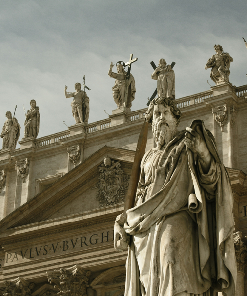 Stone statue in front of a historic classical building