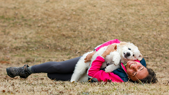 dog owner cuddling with her dog