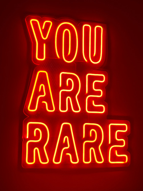 Red neon sign that states, You Are Rare